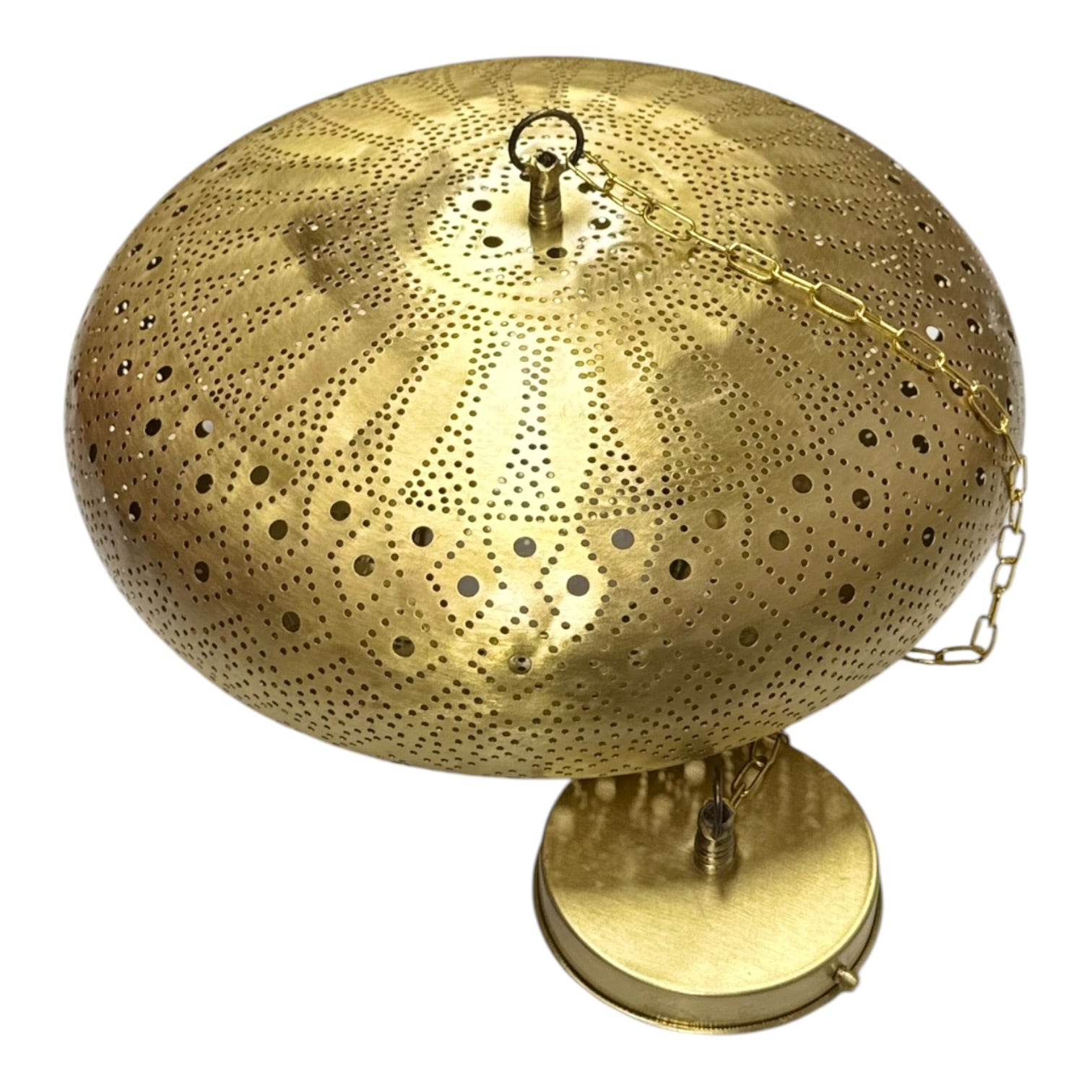 Decorative gold metal lamp with intricate design on a white background