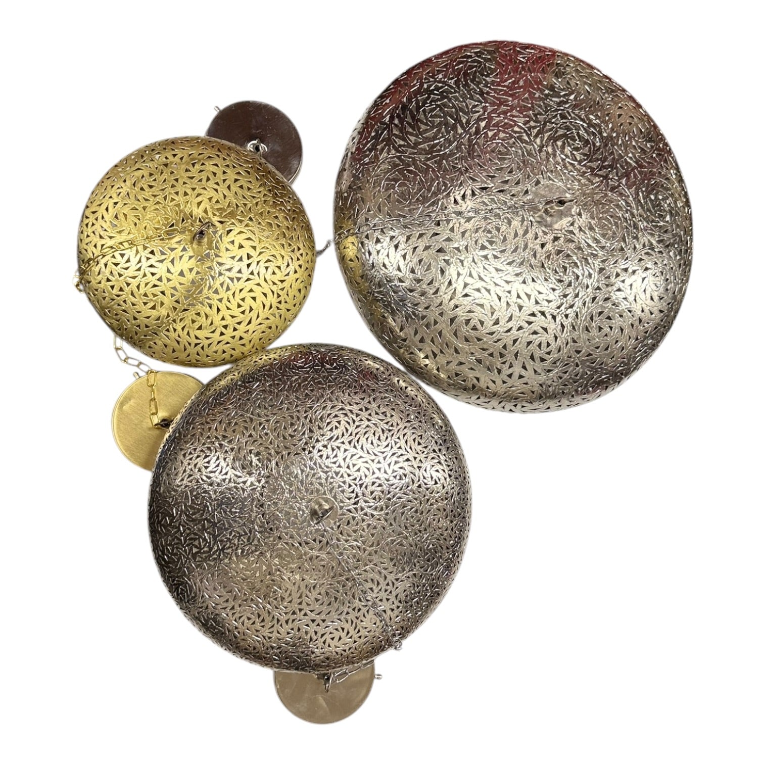 Decorative metal balls with intricate patterns on a white background