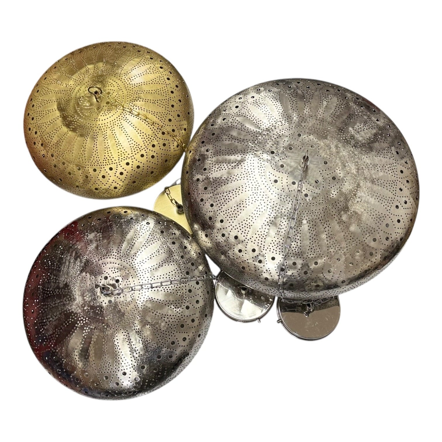 Three decorative items resembling sea urchins in metallic gold, silver, and bronze on a white background.