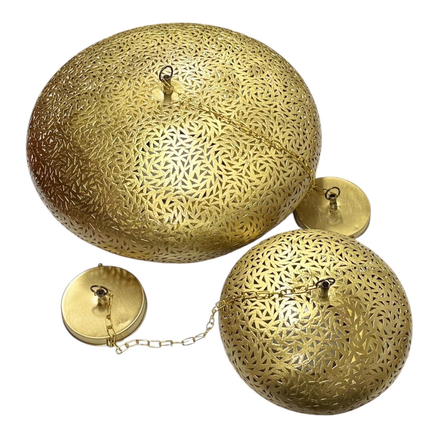 Decorative gold lampshades with intricate patterns on a white background