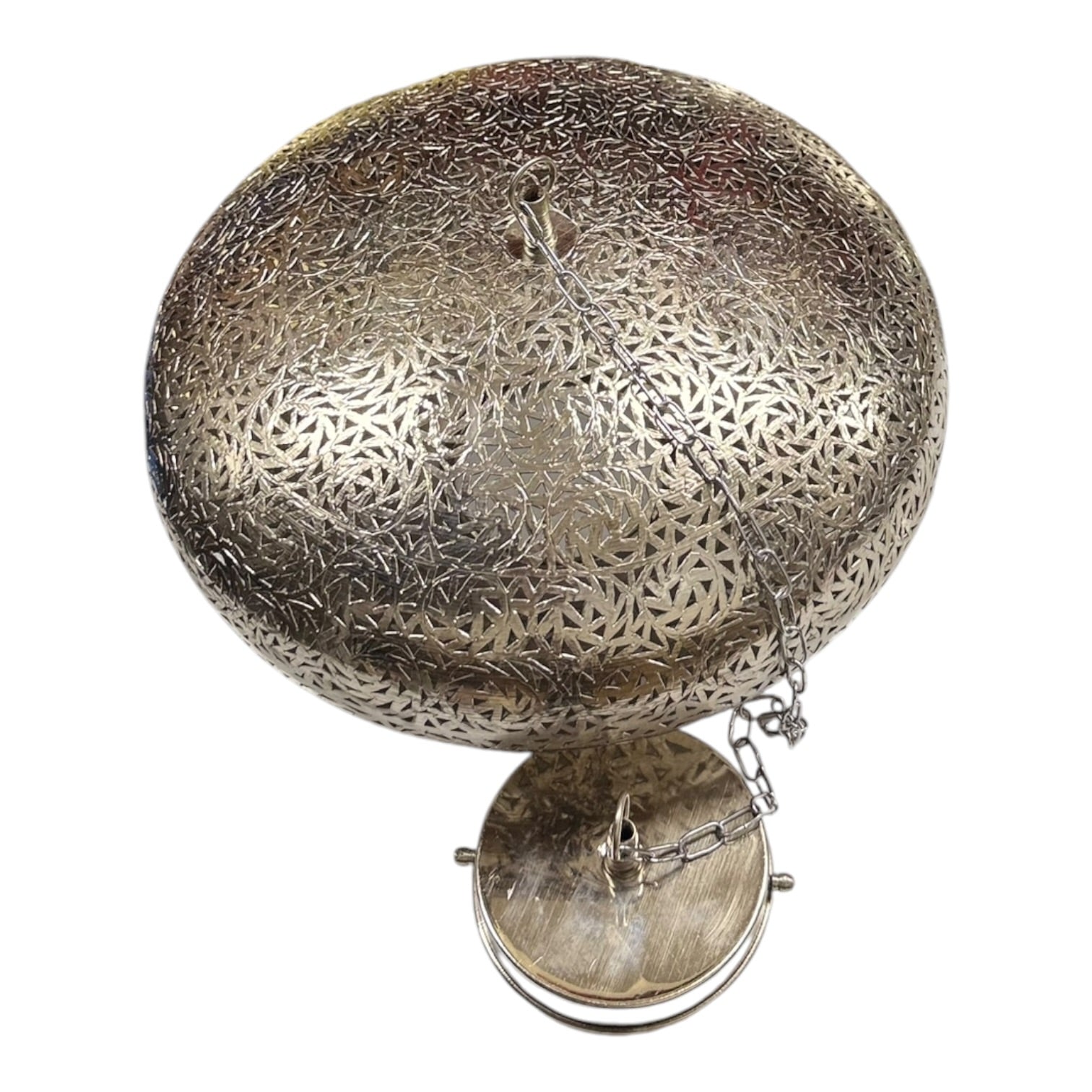 Decorative silver metal object with intricate patterns on a white background
