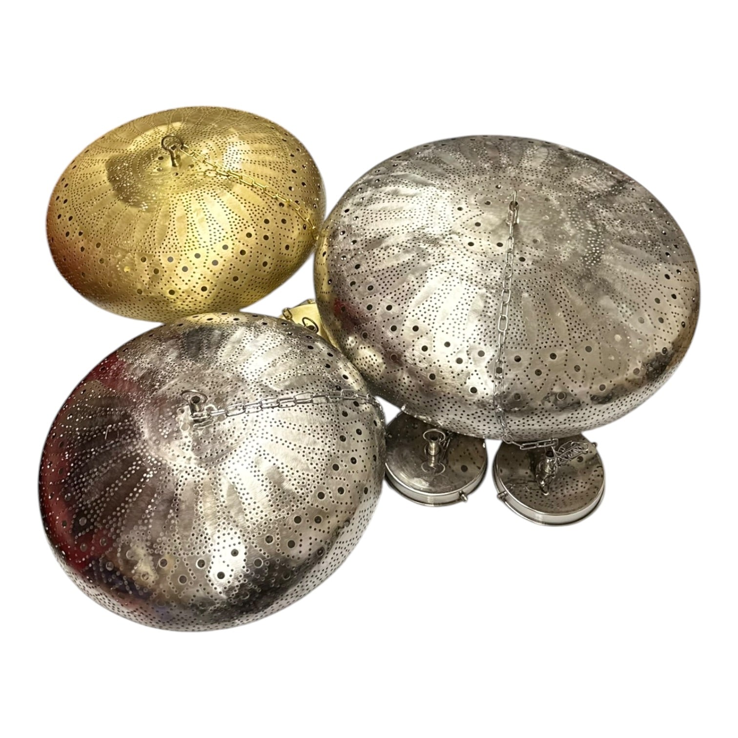 Three decorative metal lids with textured surfaces on a white background