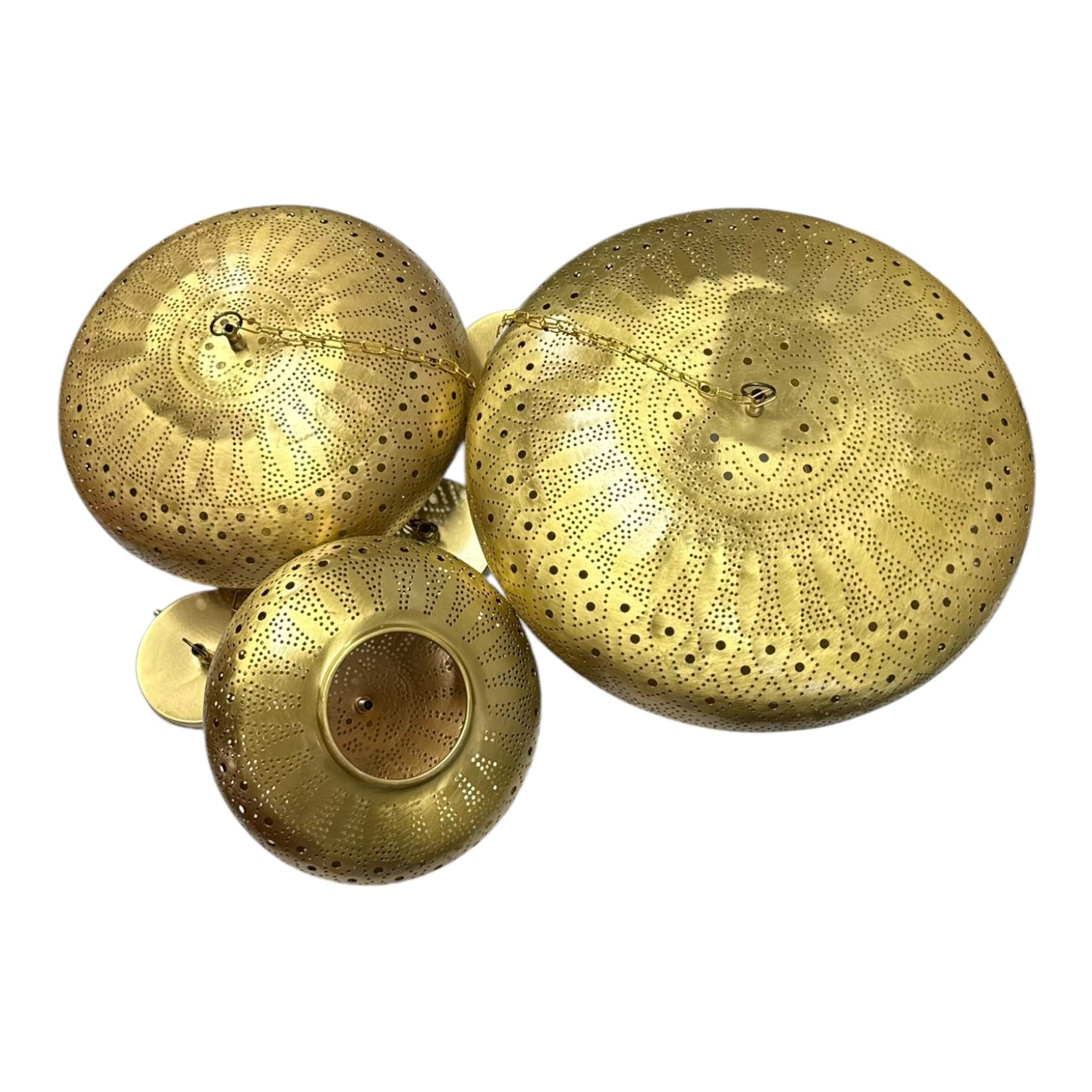 Three gold decorative lids on a white background