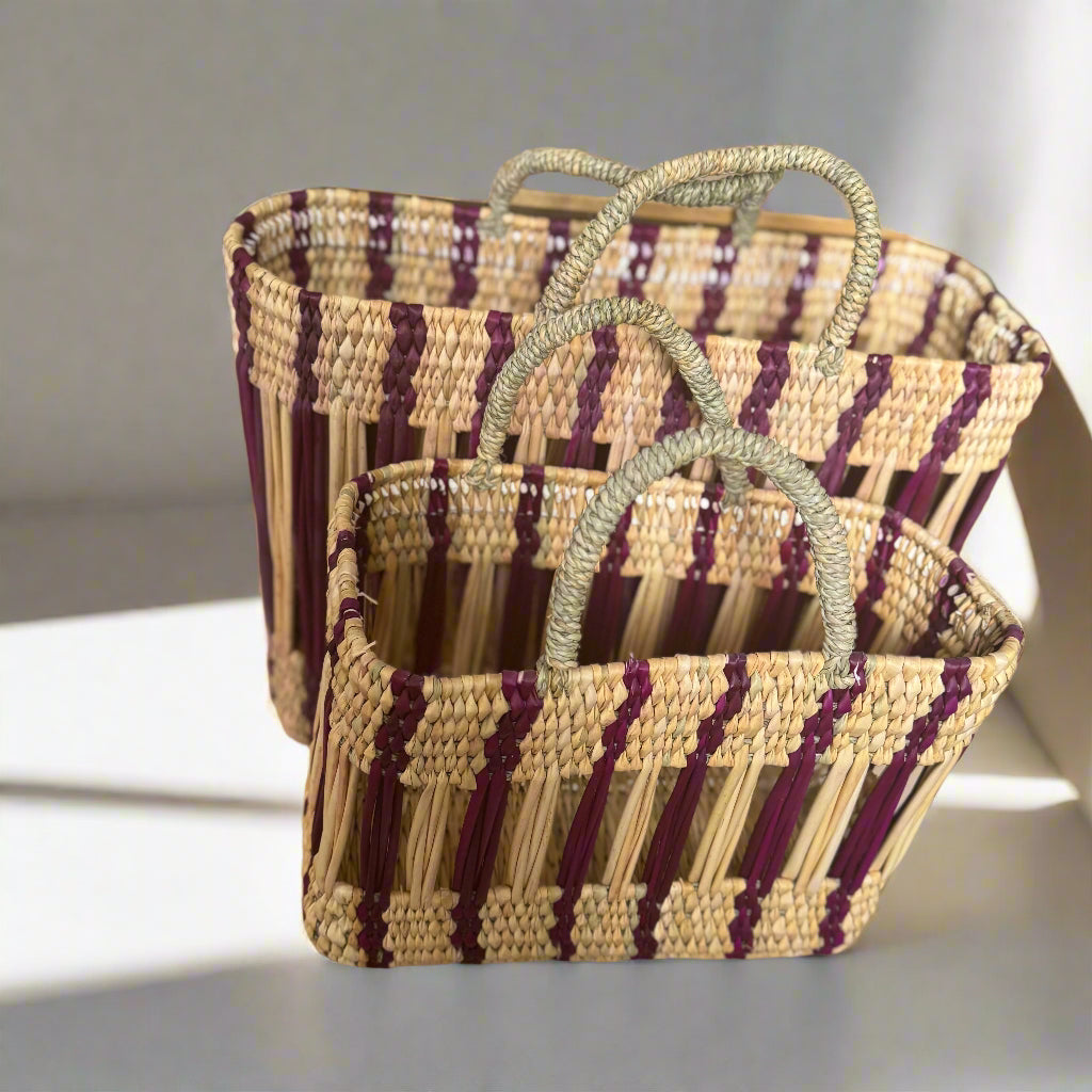 Woven bags with purple and beige stripes on a wooden surface.