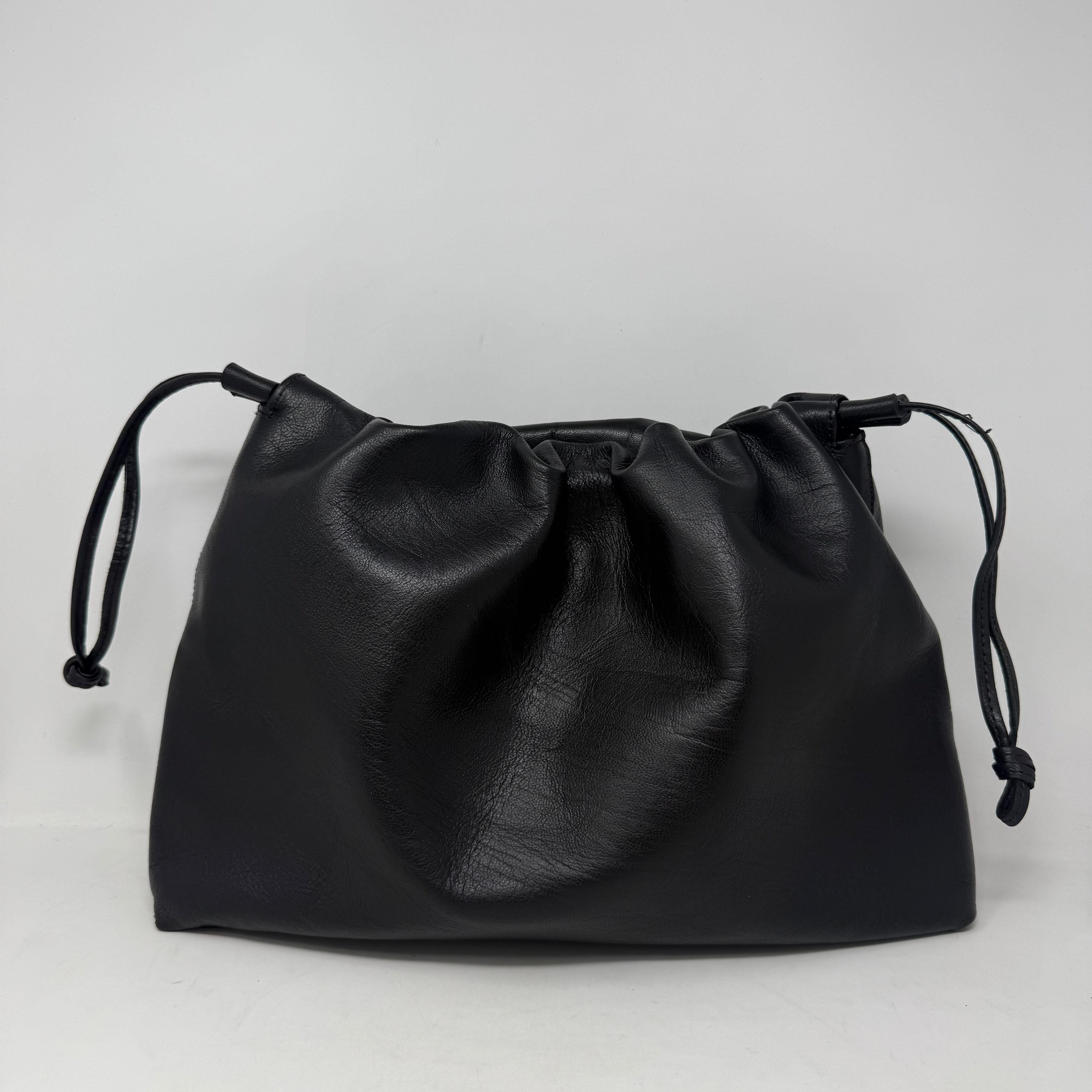 Black drawstring pouch on a light gray background