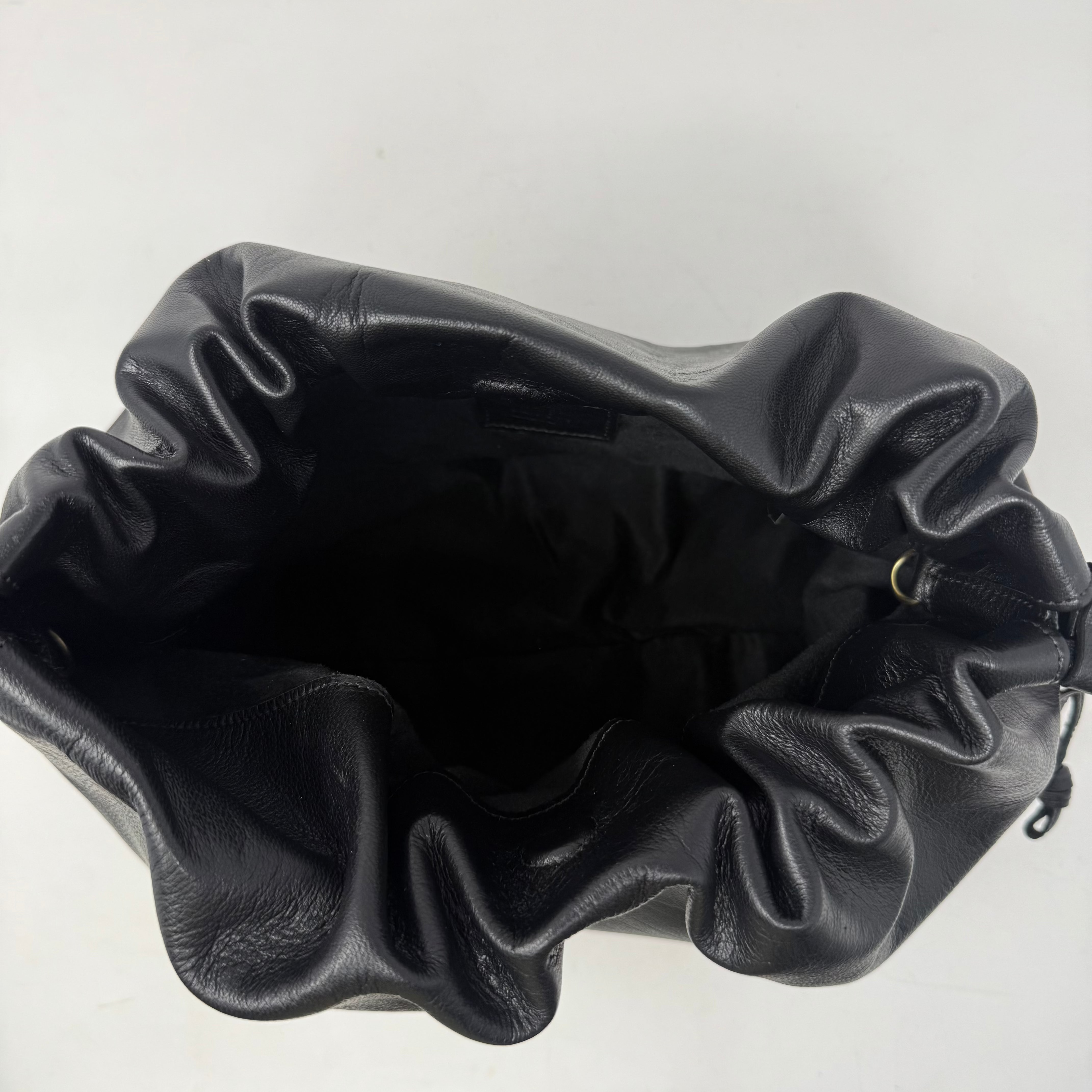 Black leather drawstring bag on a white background