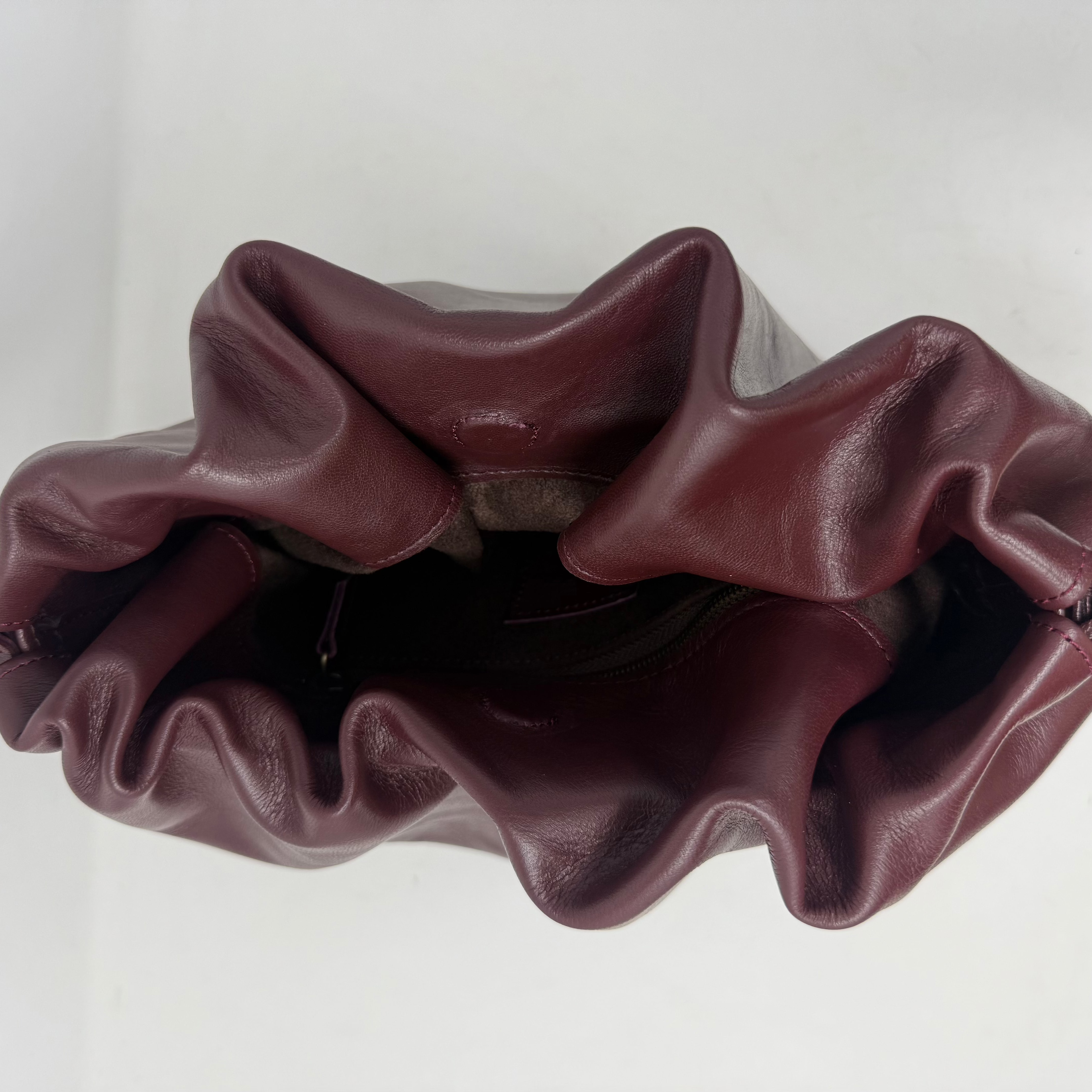 Maroon scrunchie on a light gray background