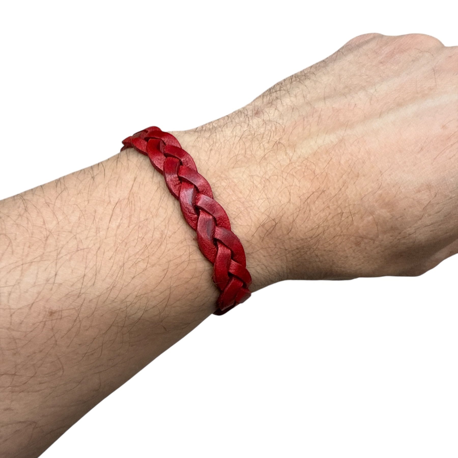 Hand wearing a red handmade braided leather bracelet on white background