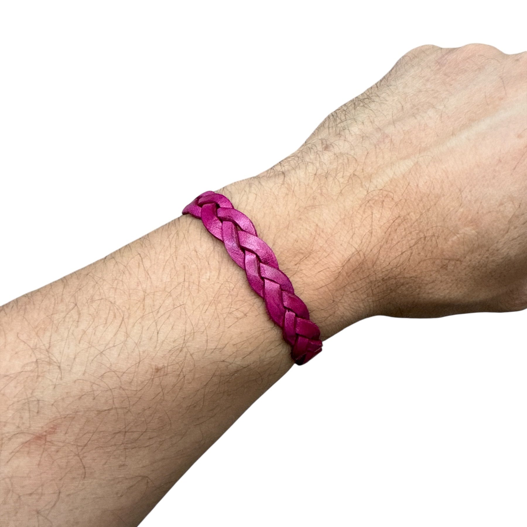Hand wearing handmade braided leather bracelet in vibrant pink color