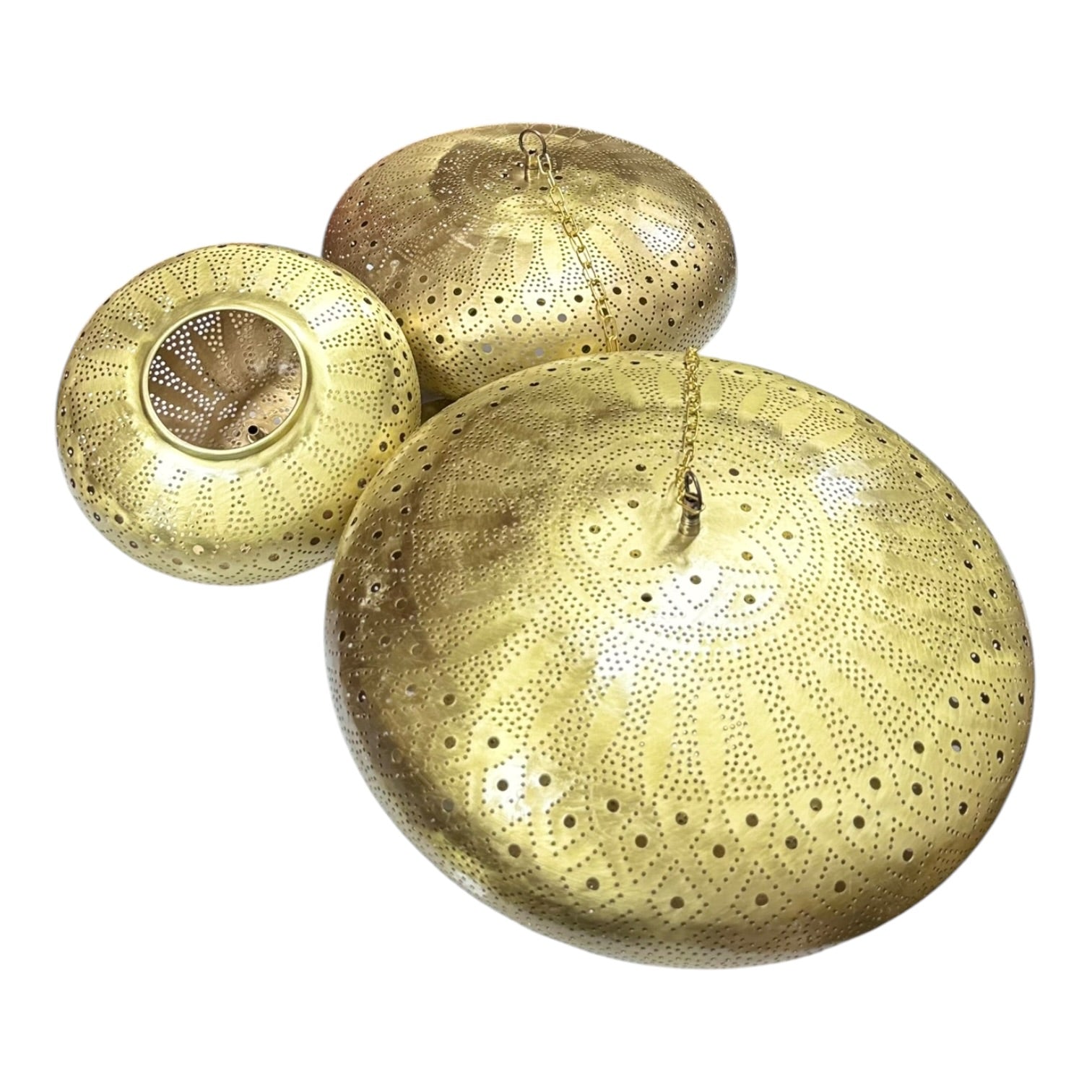 Three gold decorative bowls with intricate patterns on a white background