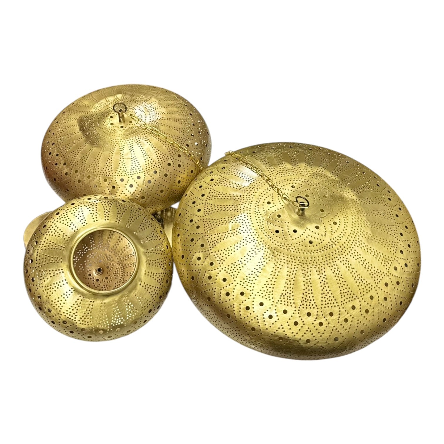 Three gold decorative lids with intricate patterns on a white background