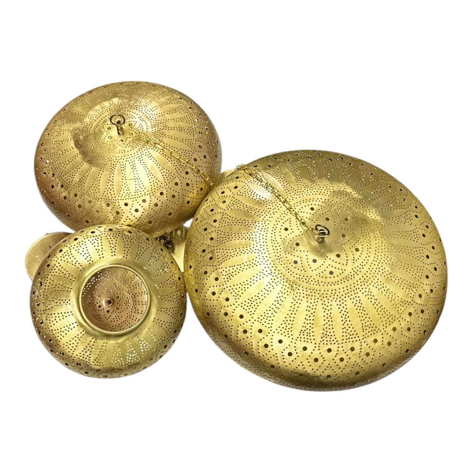 Three gold decorative lids on a white background