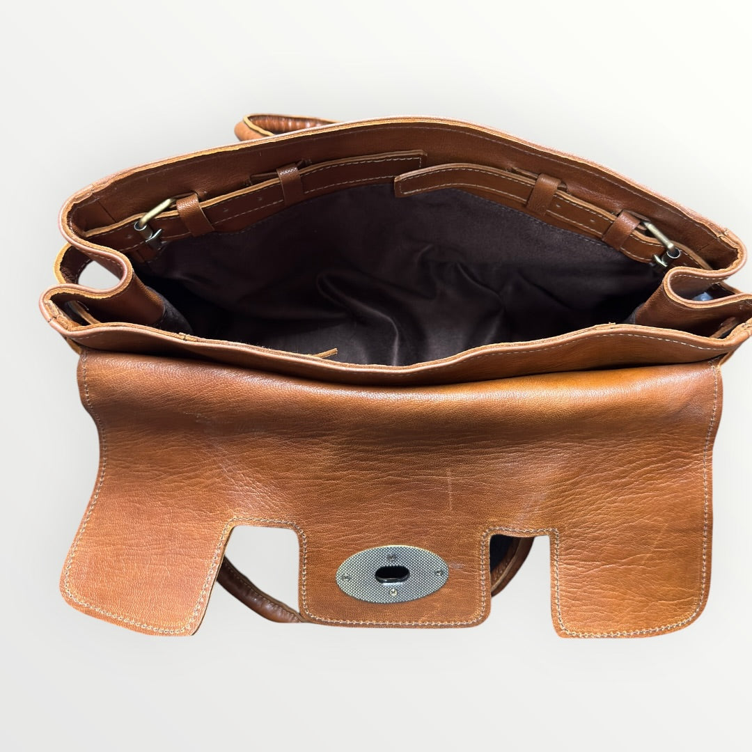 Brown leather bag with a visible brand logo on a white background