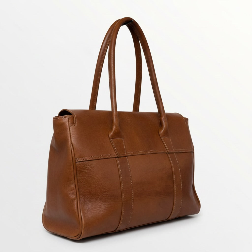 Brown leather handbag on a white background