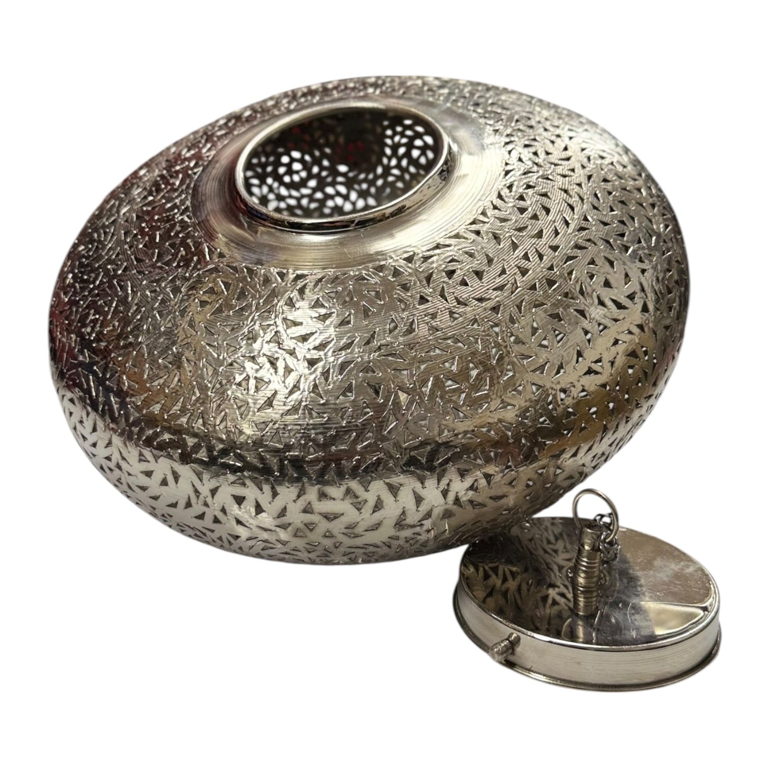 Decorative metal lantern with intricate patterns on a white background