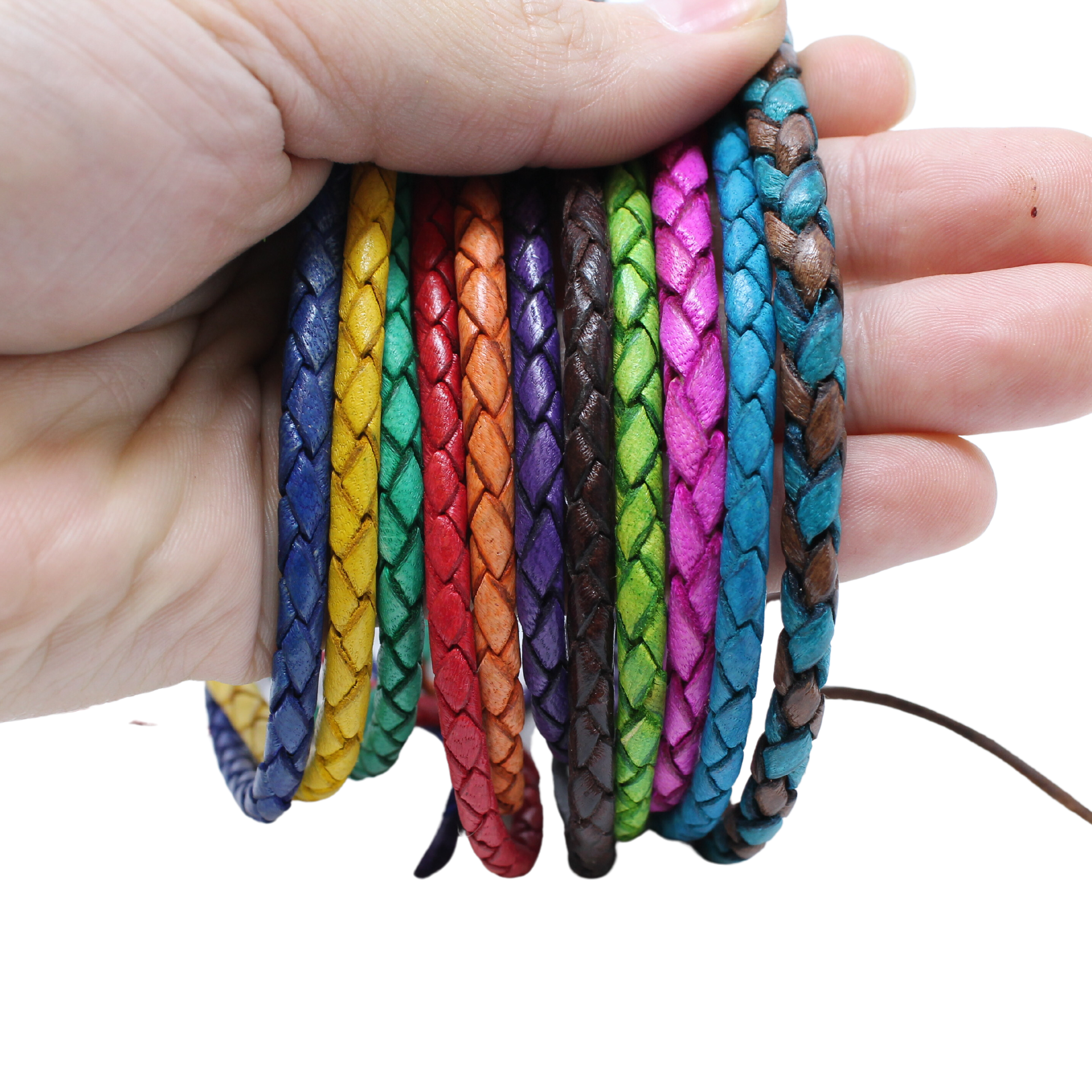 Adjustable twisted artisan leather bracelet jewelry for men and women in multiple vibrant colors held in hand
