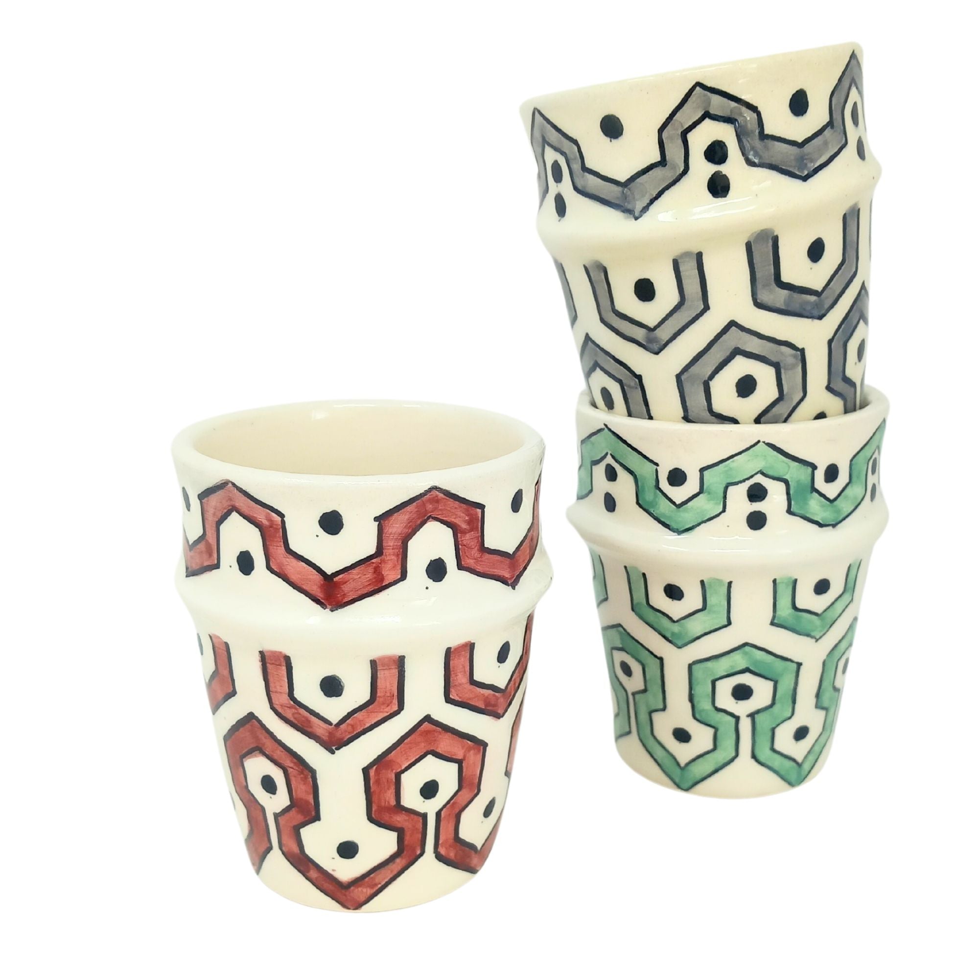 picture of three ceramic cups which have been fully handcrafted by artisans. In colours Burgundy red, mint Green and Grey.