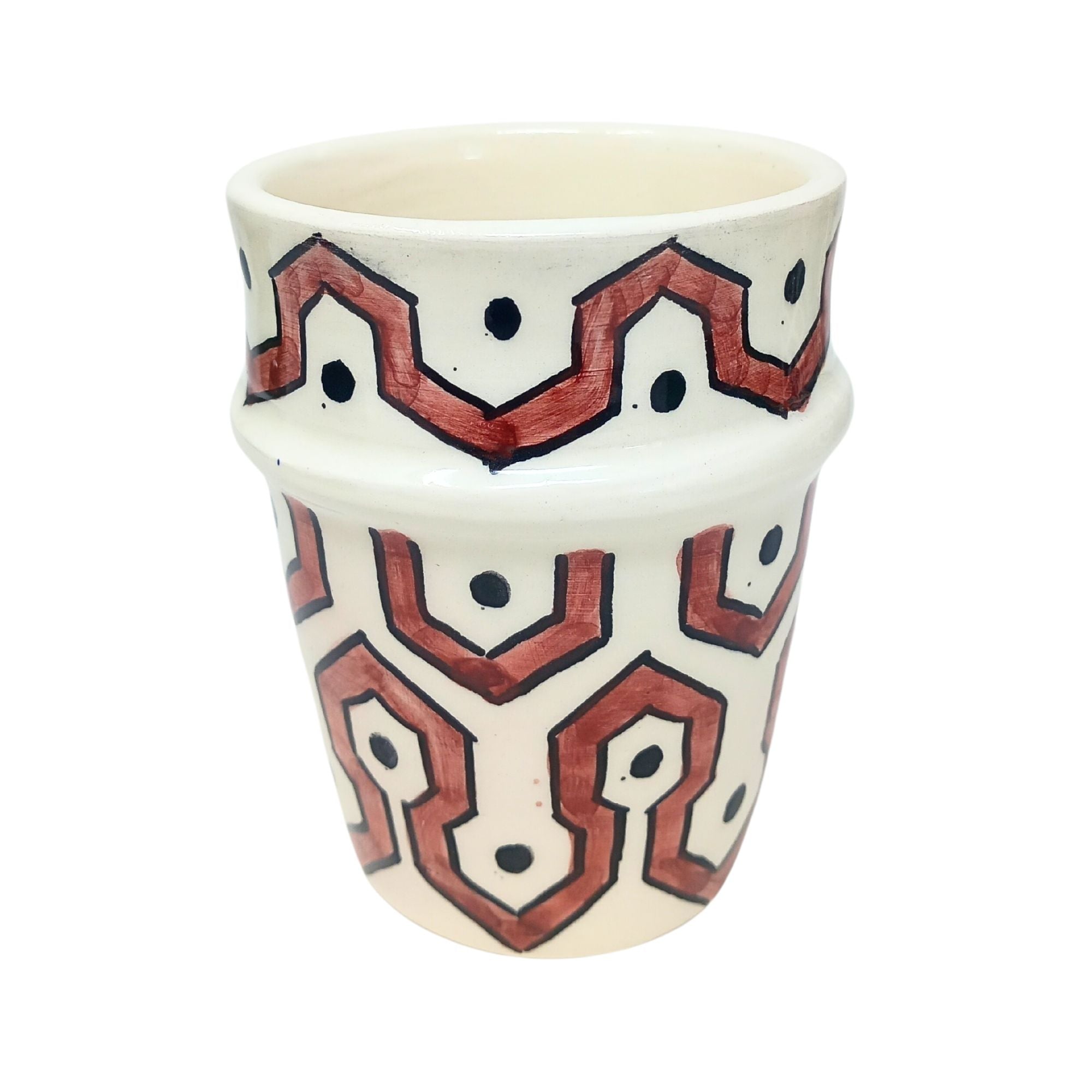 picture of a ceramic cup which has been fully handcrafted by artisans. In Burgundy red