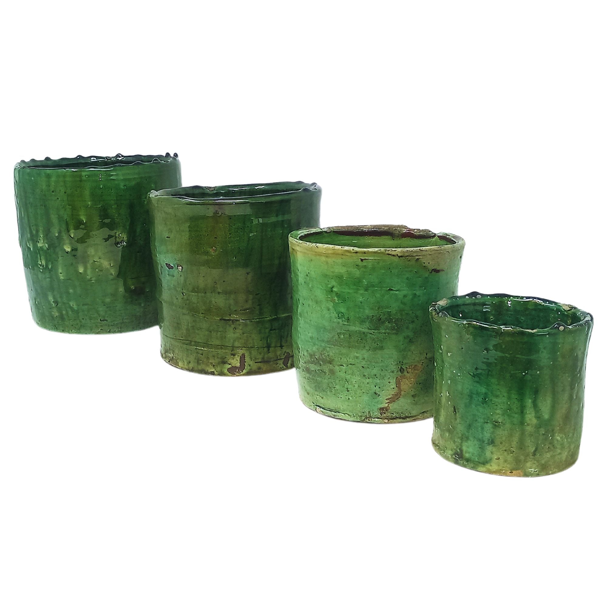 picture of four different sizes of tamegroute pots in dark green hues