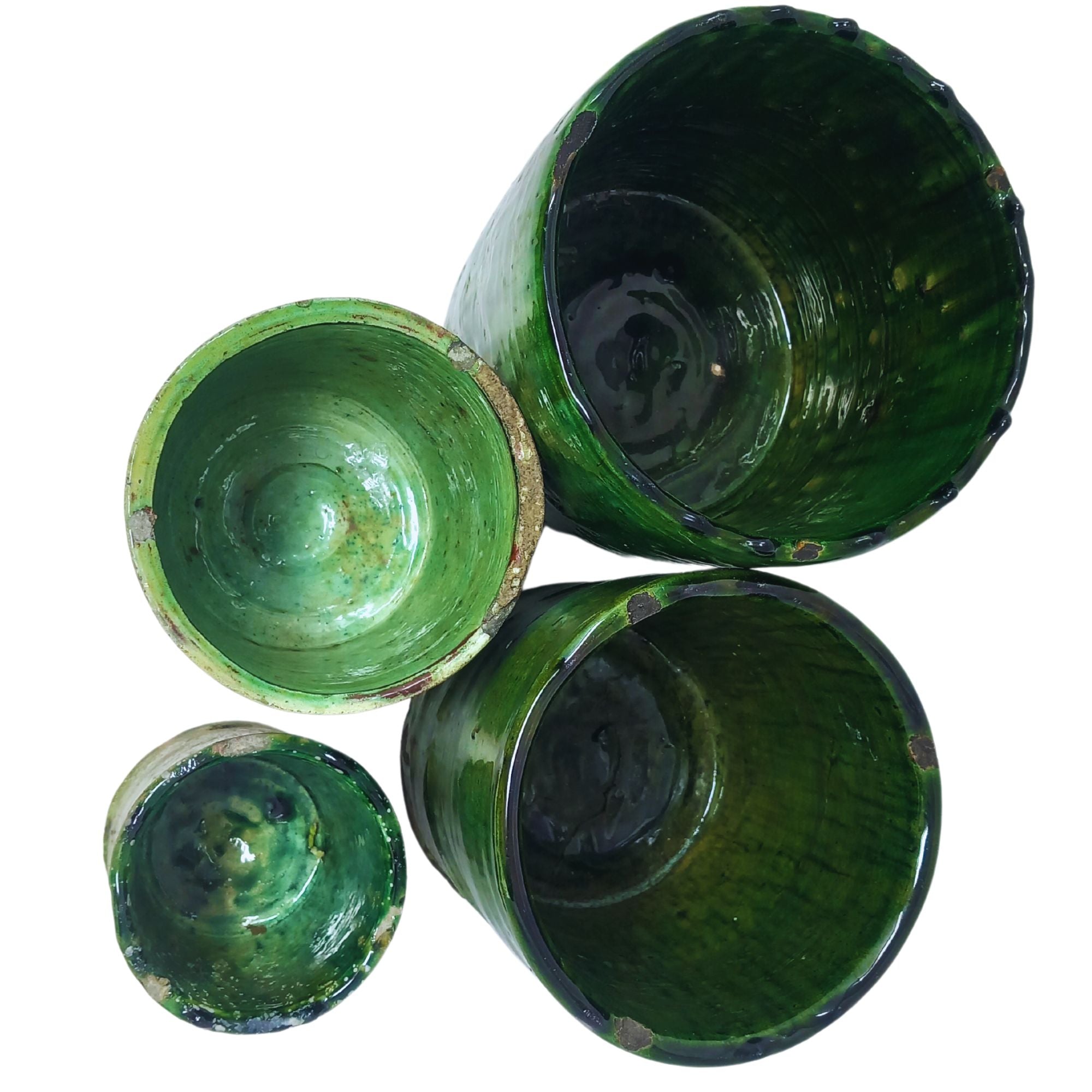 picture of four different sizes of tamegroute pots in dark green hues top view