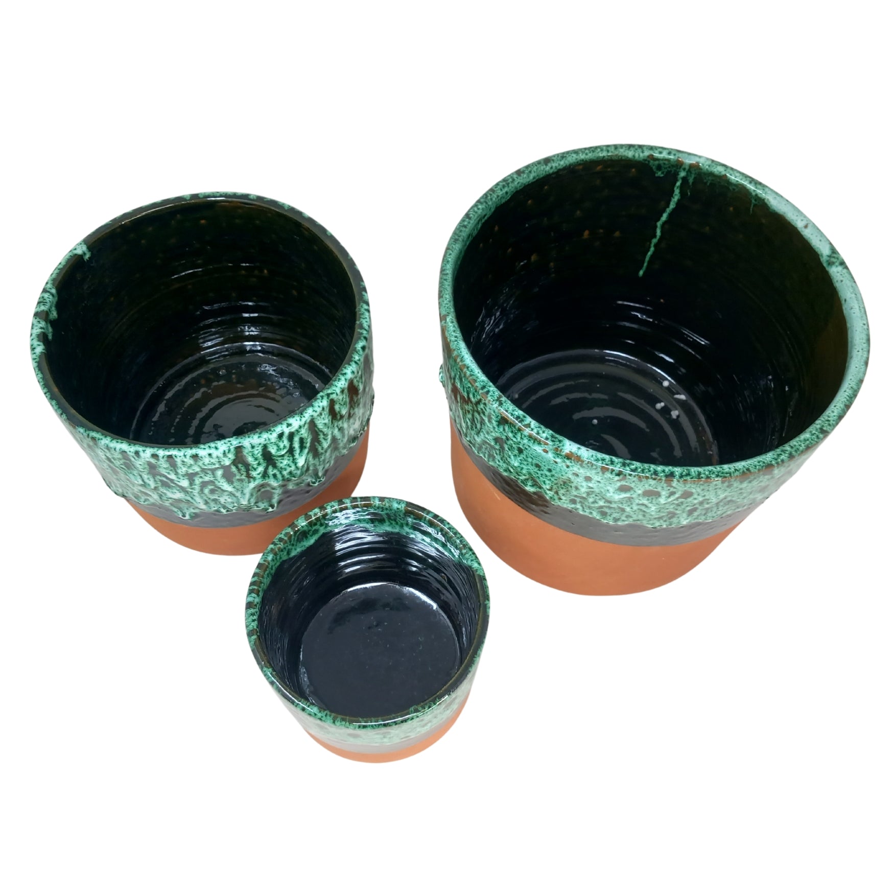 picture of three different sizes of handcrafted terracotta overpot with a green drip design top view