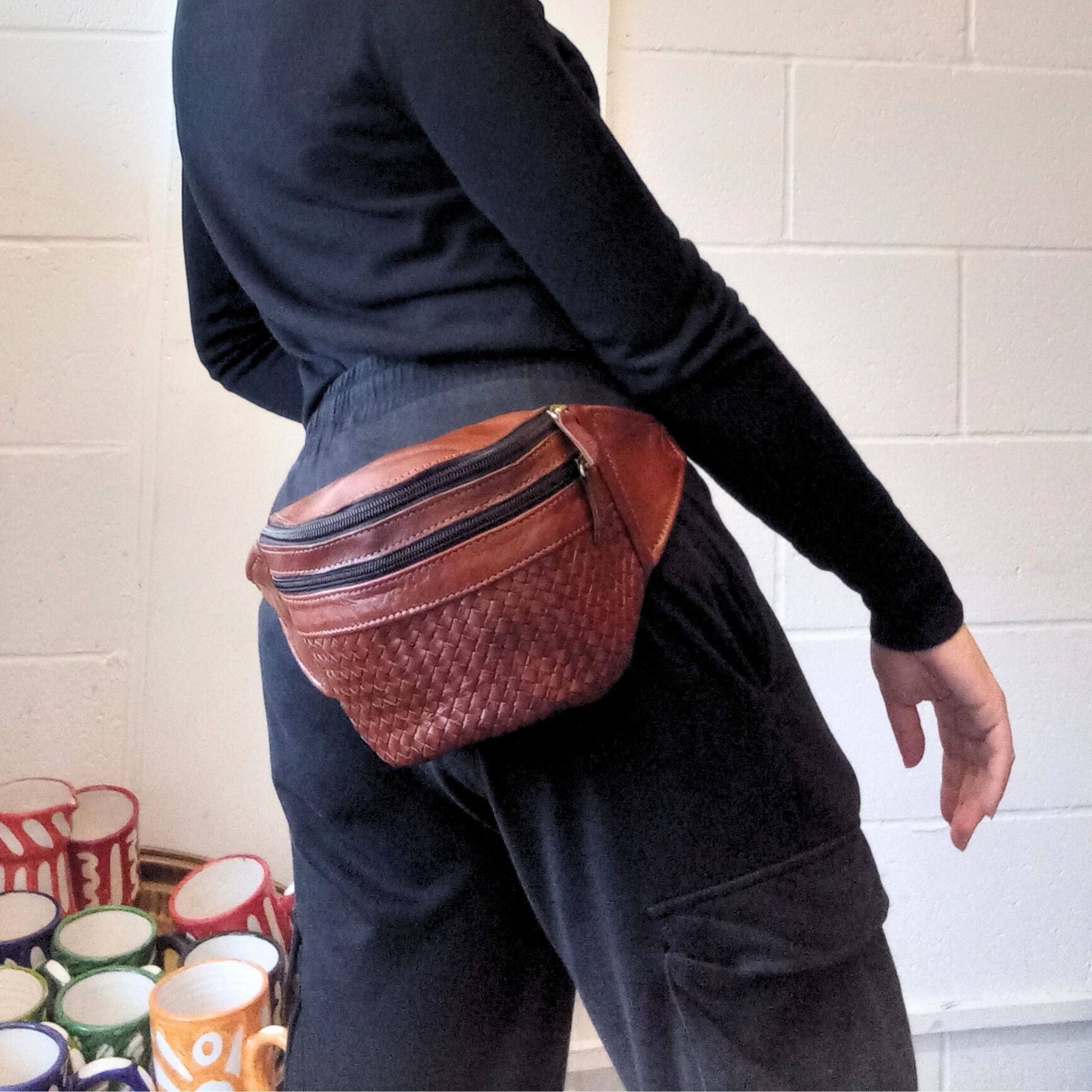 model with a leather bum bag in tan brown