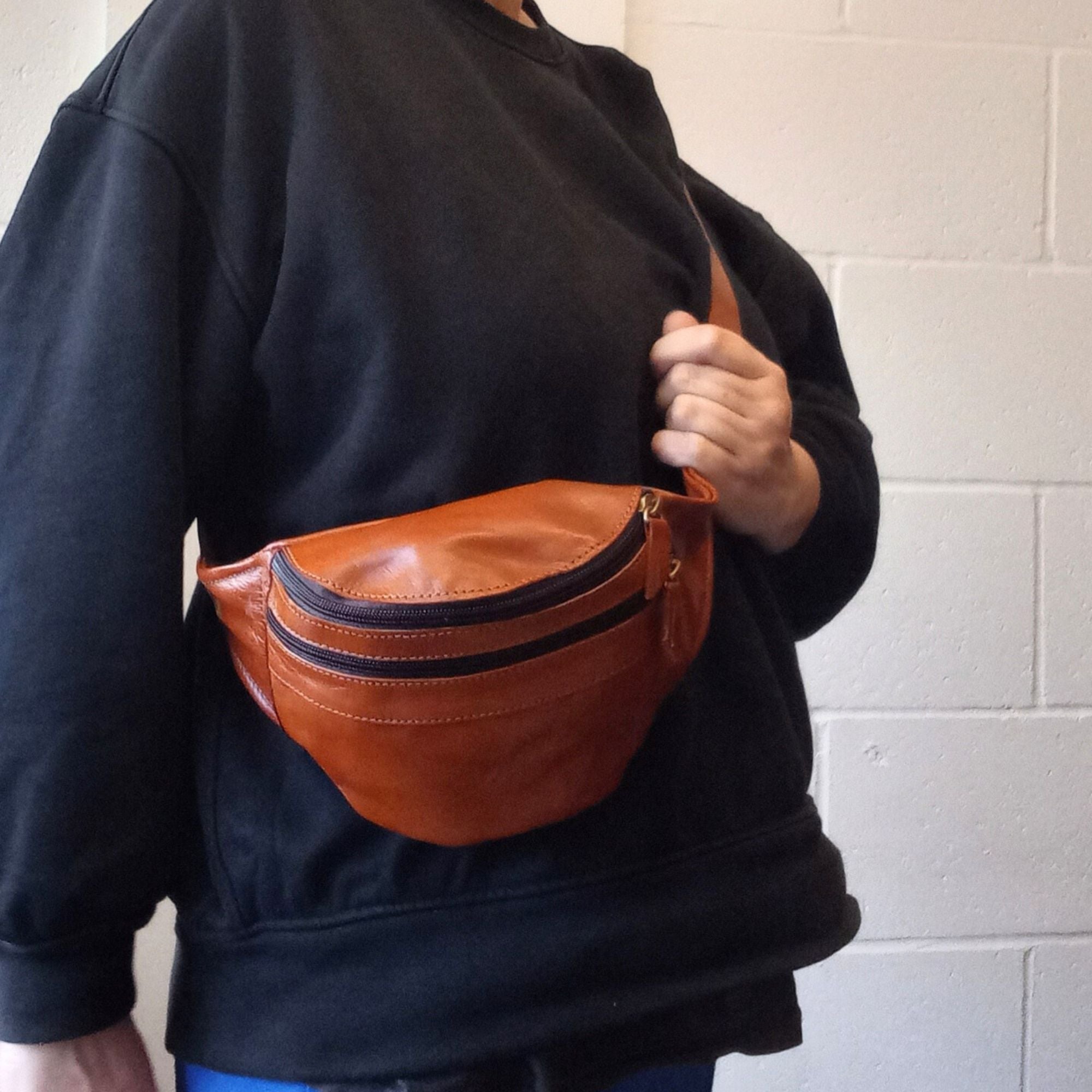model with a leather bum bag in tan brown